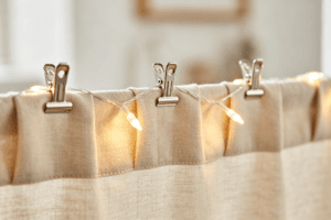 curtain clips holding fairy lights on drapes close up installation detail